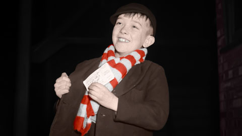 Young Brentford fan with match ticket